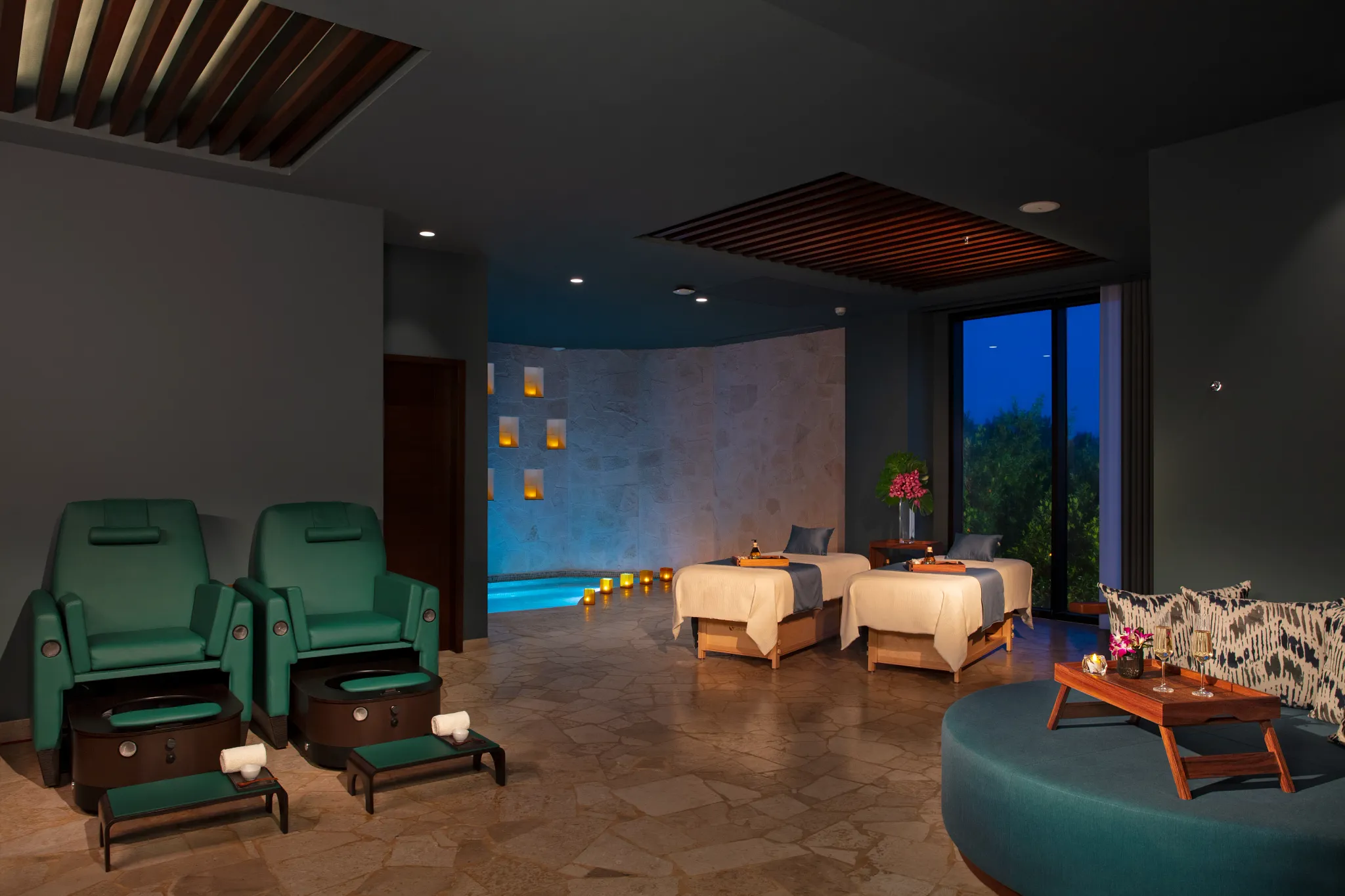 Couples massage treatment room with soft lighting and relaxation area at Dreams Natura Resort & Spa.
