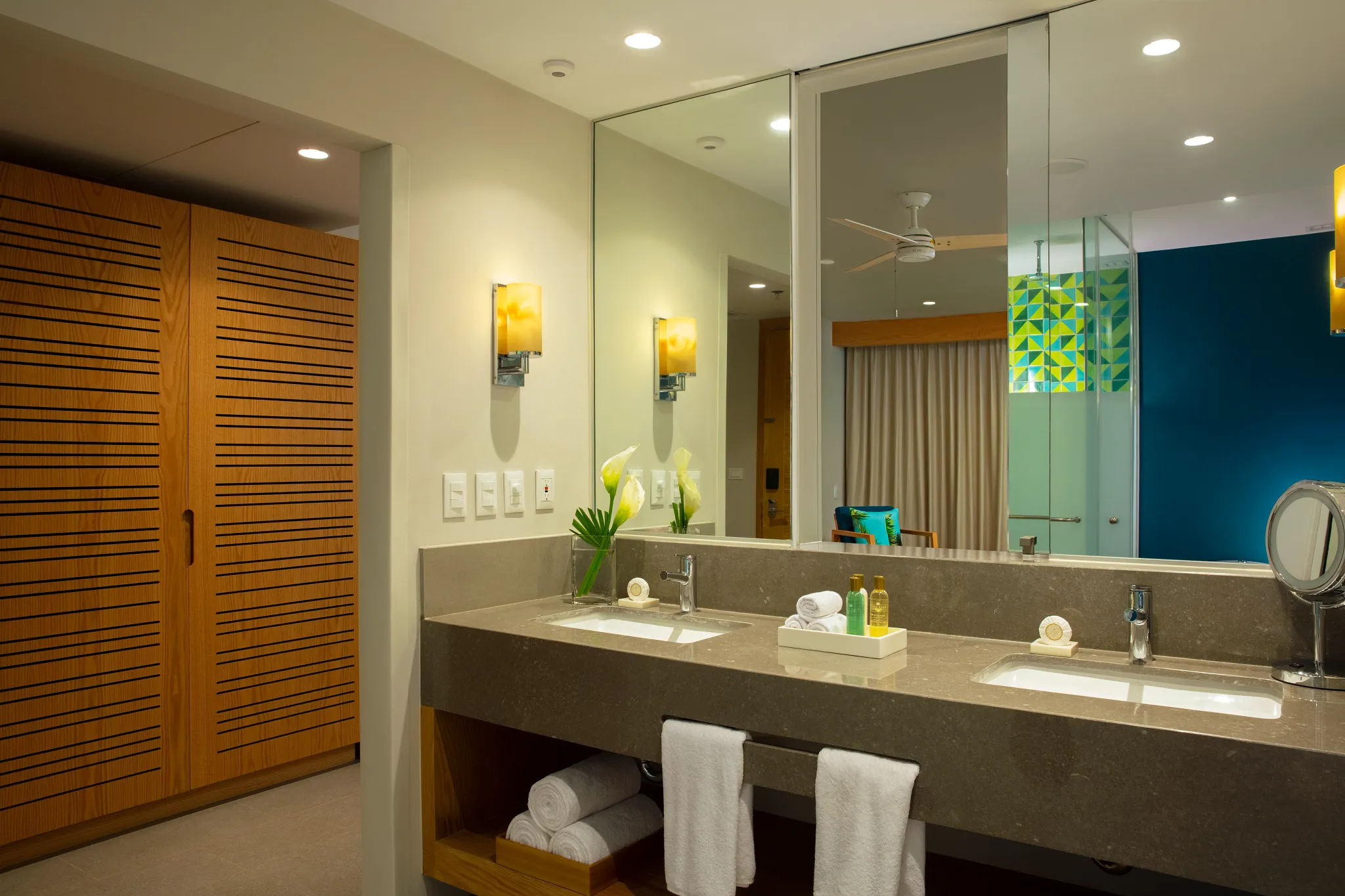 Junior Suite Swim Out bathroom with double vanity and large mirror at Dreams Natura Resort & Spa.