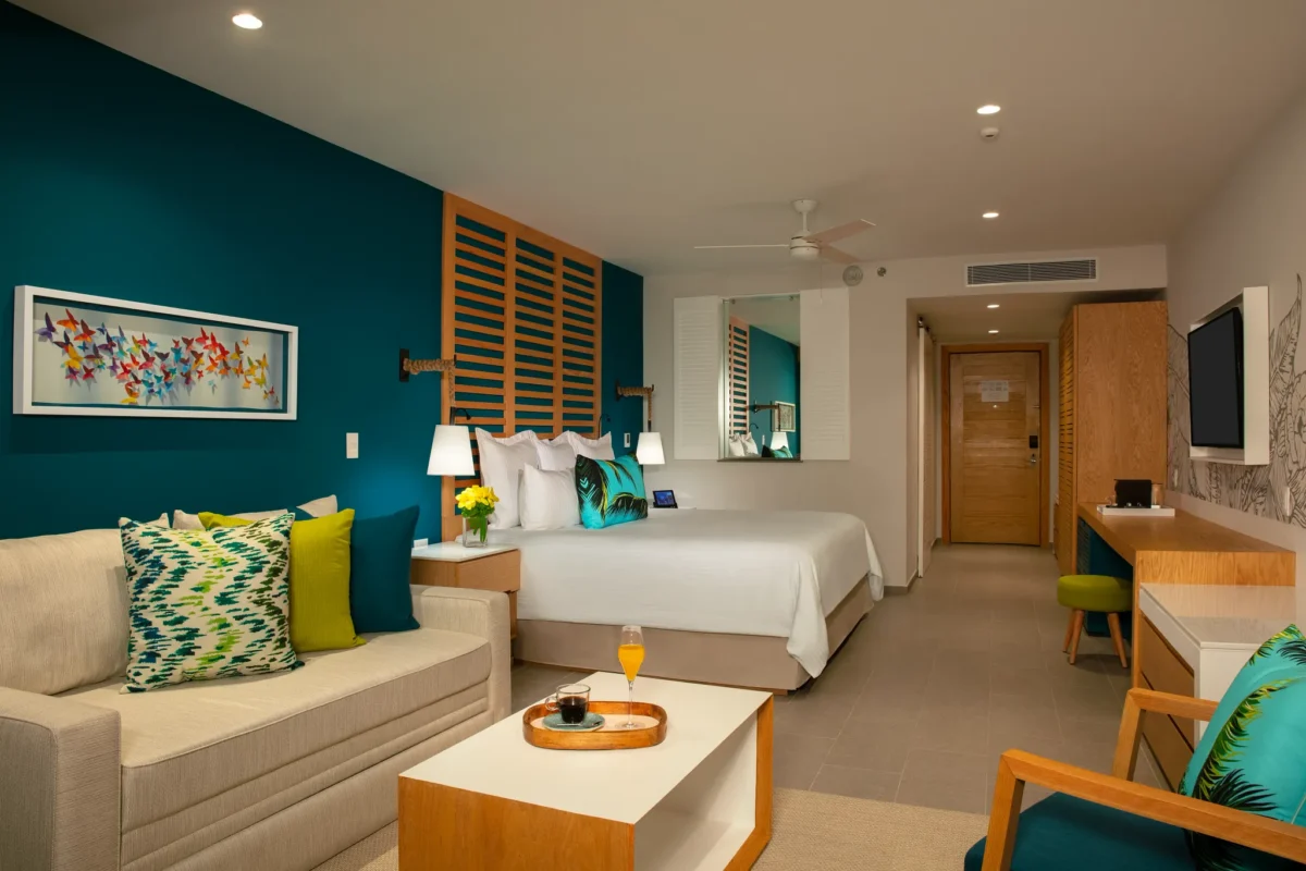 Junior Suite Swim Out with king bed and seating area at Dreams Natura Resort & Spa.
