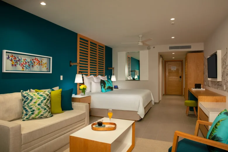 Junior Suite Swim Out with king bed and seating area at Dreams Natura Resort & Spa.