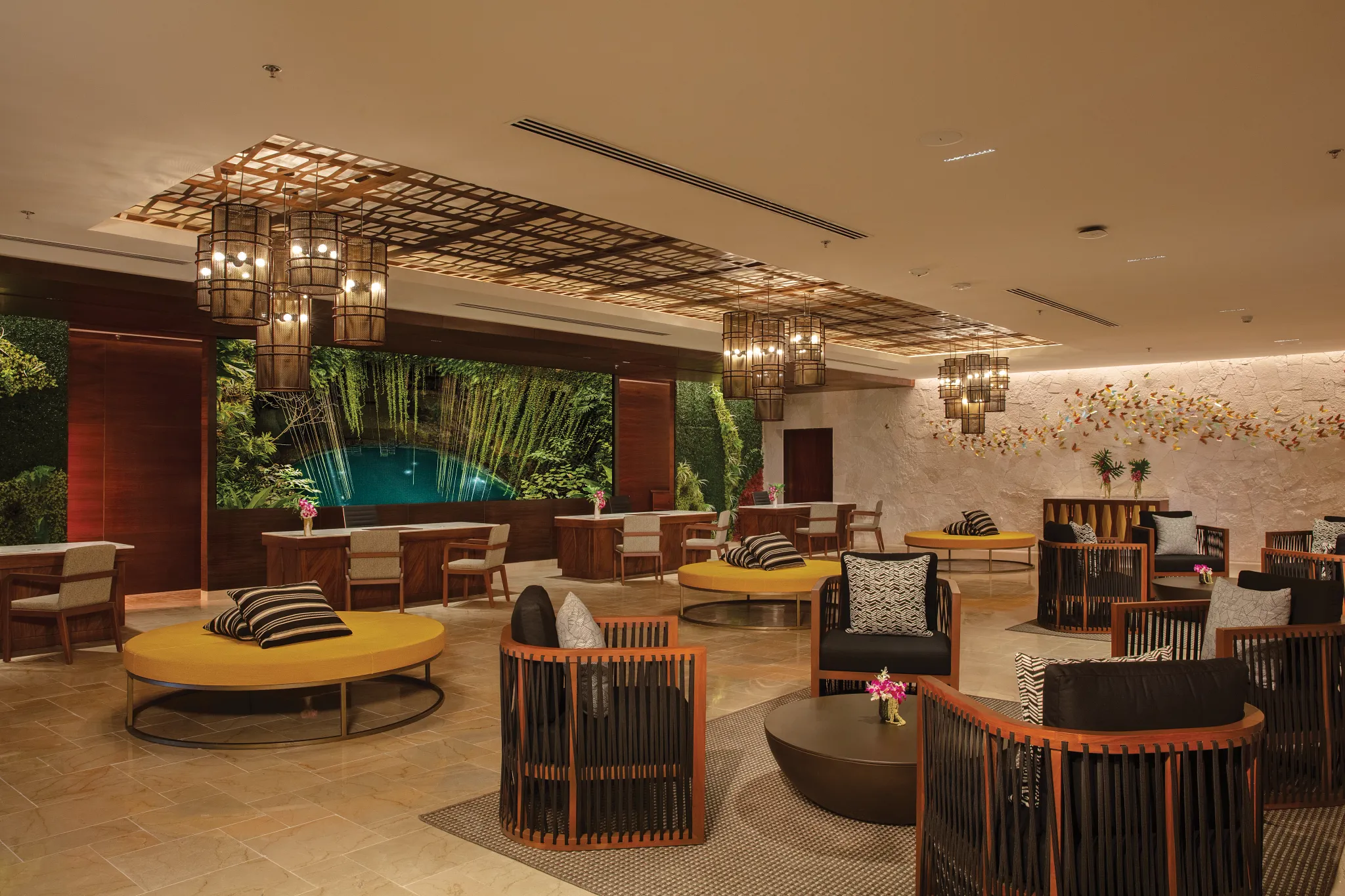 Elegant lobby lounge with modern seating and tropical design at Dreams Natura Resort & Spa in Riviera Cancun.