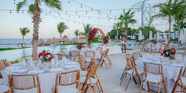 Pool terrace wedding reception setup with modern décor at Dreams Natura Resort & Spa