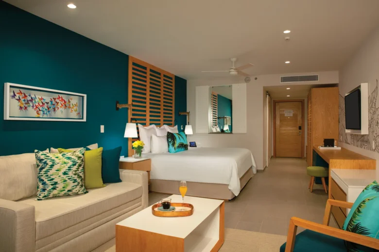 Preferred Club Family Suite Ocean View with king bed and living space at Dreams Natura Resort & Spa.