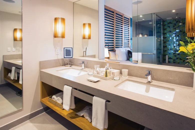 Preferred Club Junior Suite Ocean View bathroom with double sinks and large mirror at Dreams Natura Resort & Spa.