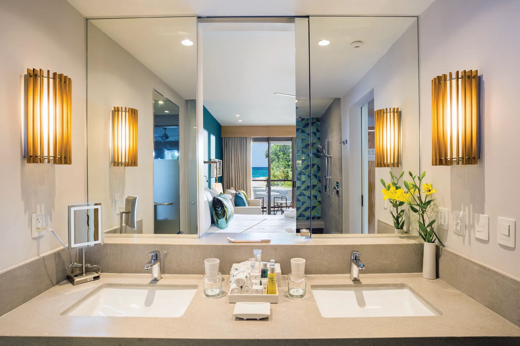 Preferred Club Junior Suite Swim Out bathroom with double sinks and large mirror at Dreams Natura Resort & Spa.