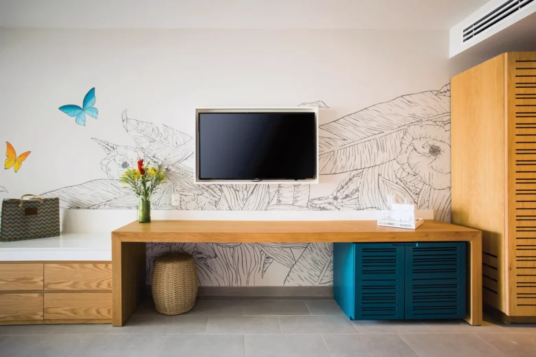 Preferred Club Junior Suite Swim Out workspace with TV and modern décor at Dreams Natura Resort & Spa.