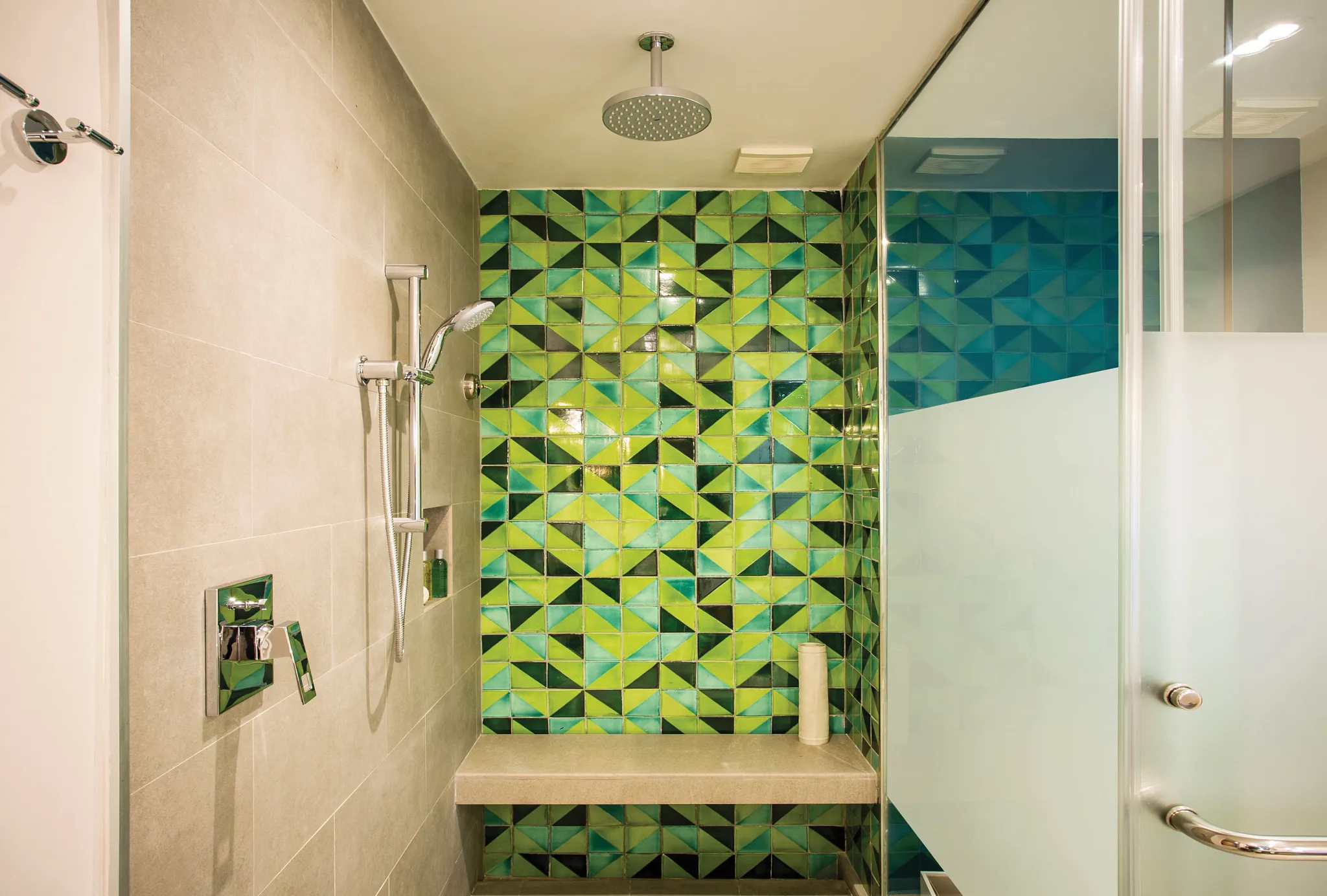 Preferred Club Junior Suite walk-in shower with rainfall showerhead and green tile at Dreams Natura Resort & Spa.