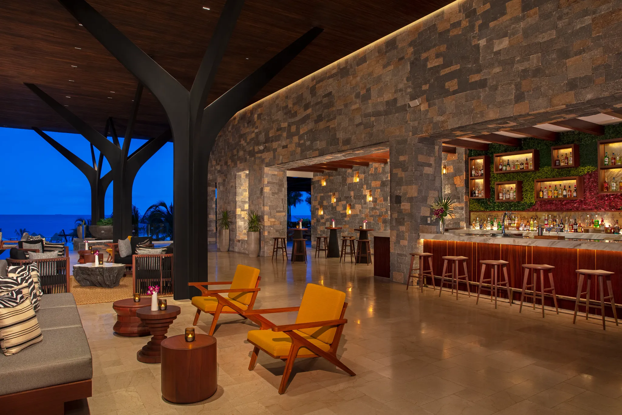 Rendezvous lobby bar at Dreams Natura Resort & Spa featuring open-air seating, panoramic ocean views, and handcrafted cocktails.